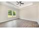 A minimalist bedroom showcases hardwood floors, natural light, and a tray ceiling at 722 English St, Monroe, NC 28110