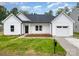 Charming, newly constructed single-Gathering home features a manicured lawn and an attached garage at 722 English St, Monroe, NC 28110