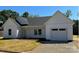 Charming one-story home with white siding, an attached garage, and a well-manicured lawn at 722 English St, Monroe, NC 28110