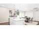 A modern kitchen features an island with a sink, stainless steel appliances, and an adjacent dining area at 722 English St, Monroe, NC 28110