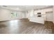 Bright living room adjacent to kitchen, featuring wood-look flooring and ample natural light at 722 English St, Monroe, NC 28110