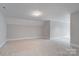 Spacious carpeted basement with neutral paint at 7358 Bay Cove Ct, Denver, NC 28037