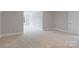 Finished basement area features neutral carpet, paint, and baseboards at 7358 Bay Cove Ct, Denver, NC 28037