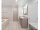 Neutral bathroom featuring tile floor, double vanity, soaking tub, and tiled walk-in shower at 7358 Bay Cove Ct, Denver, NC 28037