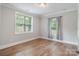 Bright bedroom with hardwood floors and a large window letting in lots of natural light at 7358 Bay Cove Ct, Denver, NC 28037