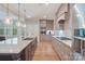 Spacious kitchen featuring a center island, stylish pendant lighting, and modern appliances at 7358 Bay Cove Ct, Denver, NC 28037