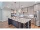 Modern kitchen with a large center island, pendant lights, and stainless steel appliances at 7358 Bay Cove Ct, Denver, NC 28037