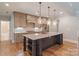 Modern kitchen with a center island, pendant lighting, and stainless steel appliances at 7358 Bay Cove Ct, Denver, NC 28037