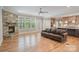 Cozy living room with a stone fireplace, hardwood floors, and an open kitchen layout at 7358 Bay Cove Ct, Denver, NC 28037