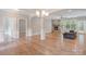Spacious living area featuring hardwood floors, a stone fireplace, and abundant natural light at 7358 Bay Cove Ct, Denver, NC 28037