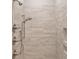 Contemporary shower featuring stylish tile work, multiple shower heads, and convenient shelving at 7358 Bay Cove Ct, Denver, NC 28037