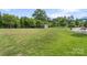 Expansive backyard featuring a lush lawn, mature trees, landscaping, and a storage shed, perfect for outdoor activities at 7405 Albemarle Dr, Denver, NC 28037