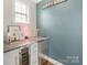 Wet bar area features beverage fridge, stone counters and cool decor at 7405 Albemarle Dr, Denver, NC 28037