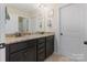 Bathroom featuring a double sink vanity with granite countertops and dark cabinetry at 7405 Albemarle Dr, Denver, NC 28037