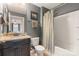 Bathroom featuring a vanity with granite countertops, a shower/tub combination, and neutral tones at 7405 Albemarle Dr, Denver, NC 28037