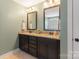 Bathroom featuring a double sink vanity with granite countertops and dark cabinetry at 7405 Albemarle Dr, Denver, NC 28037