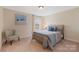 Cozy bedroom featuring a comfortable bed and a decorative accent chair at 7405 Albemarle Dr, Denver, NC 28037