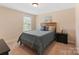 Cozy bedroom with carpet featuring a comfortable bed and ample natural light at 7405 Albemarle Dr, Denver, NC 28037