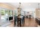 Cozy dining area offering a view to the outdoor pool area and a glimpse into the open-concept living space at 7405 Albemarle Dr, Denver, NC 28037