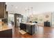 This kitchen features stainless steel appliances, granite countertops, and dark wood cabinets at 7405 Albemarle Dr, Denver, NC 28037