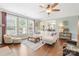Open-concept living area with hardwood floors, neutral decor, and a seamless transition to the adjacent dining space at 7405 Albemarle Dr, Denver, NC 28037