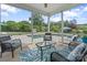 Screened in patio with outdoor furniture overlooking the backyard and pool at 7405 Albemarle Dr, Denver, NC 28037