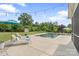 Beautiful pool area with lounge chairs, open yard, and decorative string lights at 7405 Albemarle Dr, Denver, NC 28037