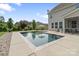 Backyard pool with a screened porch and lounge chairs, great for summer relaxation and entertaining at 7405 Albemarle Dr, Denver, NC 28037