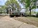 Brick home with a long driveway and a well-manicured lawn at 8205 Meadowind Cir, Charlotte, NC 28226