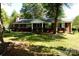 Charming one-story brick home with a well-maintained lawn and mature trees at 8205 Meadowind Cir, Charlotte, NC 28226