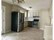 Bright kitchen with stainless steel appliances, white cabinets, and tile flooring at 8205 Meadowind Cir, Charlotte, NC 28226