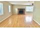 Inviting living room features beautiful hardwood floors and a cozy brick fireplace at 8205 Meadowind Cir, Charlotte, NC 28226