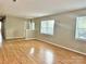 Open-concept living room with hardwood floors and lots of natural light at 8205 Meadowind Cir, Charlotte, NC 28226
