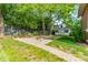 Spacious backyard with a paved patio area, landscaping, and mature trees providing ample shade at 822 W Front St, Statesville, NC 28677