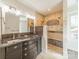 Bathroom with custom vanity, walk-in shower, and granite counters at 822 W Front St, Statesville, NC 28677