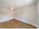 Cozy unfurnished bedroom with hardwood floors, neutral walls, and a ceiling fan at 822 W Front St, Statesville, NC 28677