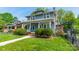 Charming two-story home with blue siding, a brick chimney and landscaped front yard at 822 W Front St, Statesville, NC 28677