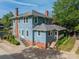 Rear exterior of a beautiful home featuring a back porch and stairs to the yard at 822 W Front St, Statesville, NC 28677