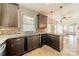 Well-lit kitchen featuring granite countertops, a gas range, and tiled backsplash and flooring at 822 W Front St, Statesville, NC 28677