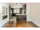 Open concept kitchen with stainless steel appliances, granite counters, and dark wood cabinetry at 822 W Front St, Statesville, NC 28677
