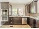Modern kitchen with dark wood cabinetry, granite countertops, stainless steel appliances, and tile flooring at 822 W Front St, Statesville, NC 28677