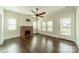 Spacious living room features a brick fireplace, hardwood flooring, and plentiful natural light at 822 W Front St, Statesville, NC 28677