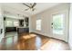Sunlit living room featuring hardwood floors, large windows, and an open entrance to the kitchen at 822 W Front St, Statesville, NC 28677