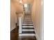 Stairway with wooden steps and white banister at 822 W Front St, Statesville, NC 28677