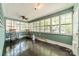 Enclosed sunroom with rocking chairs and many windows at 822 W Front St, Statesville, NC 28677