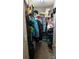 Walk-in closet with clothing, shoes, and boxes neatly organized on shelves and rods at 8524 Stoneman Pl, Charlotte, NC 28217