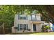 The two-story home features vinyl siding, dark shutters, and a charming front porch at 8524 Stoneman Pl, Charlotte, NC 28217