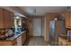 The kitchen features granite counters, tile backsplash, stainless steel fridge and tile flooring at 8524 Stoneman Pl, Charlotte, NC 28217
