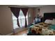 Comfortable main bedroom featuring a large bed with unique sunflower bedding at 8524 Stoneman Pl, Charlotte, NC 28217