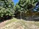 Large backyard featuring mature trees and a wooden fence for added privacy at 8551 Appledale Dr, Charlotte, NC 28262